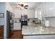 Well-lit kitchen featuring granite countertops and stainless steel appliances at 305 Monterey Ct, Benson, NC 27504