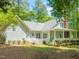 A spacious backyard with a manicured lawn, mature trees, and charming home exterior at 3201 Keighley Forest Dr, Wake Forest, NC 27587