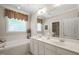 This bathroom offers a double sink vanity, large mirror, and a soaking tub for relaxation at 3201 Keighley Forest Dr, Wake Forest, NC 27587