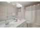 Bright bathroom features double sink vanity, large mirror, and shower with white shower curtain at 3201 Keighley Forest Dr, Wake Forest, NC 27587