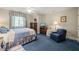 Spacious bedroom featuring blue carpet, a floral-themed bed, and ample space for a sitting area at 3201 Keighley Forest Dr, Wake Forest, NC 27587