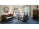 Comfortable bedroom with blue carpet and floral bedding, complemented by dark wood furnishings at 3201 Keighley Forest Dr, Wake Forest, NC 27587