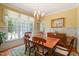 Bright dining room with large windows, yellow wallpaper, and a chandelier at 3201 Keighley Forest Dr, Wake Forest, NC 27587