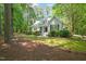 A charming home featuring a red front door, dormer windows and beautiful landscaping at 3201 Keighley Forest Dr, Wake Forest, NC 27587