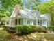 Charming home featuring a stone chimney, dormer windows, covered porch and beautiful landscaping at 3201 Keighley Forest Dr, Wake Forest, NC 27587