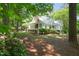 Beautifully landscaped front yard with mature trees, flowering shrubs and an inviting home exterior at 3201 Keighley Forest Dr, Wake Forest, NC 27587