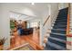 Open-concept living room with hardwood floors, a fireplace, and a staircase at 3201 Keighley Forest Dr, Wake Forest, NC 27587