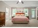 This bedroom offers carpeted floors, bright natural light from the windows, and a doorway to the bathroom at 3201 Keighley Forest Dr, Wake Forest, NC 27587