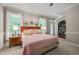 This bedroom features a comfortable bed, carpeted floors, and bright natural light from the windows at 3201 Keighley Forest Dr, Wake Forest, NC 27587