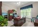 A home office with a large wooden desk, a comfortable chair, and a window at 3201 Keighley Forest Dr, Wake Forest, NC 27587