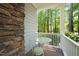 Cozy screened-in porch with stone wall, table and chairs set providing an intimate outdoor dining space at 3201 Keighley Forest Dr, Wake Forest, NC 27587