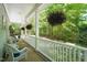 Covered porch with greenery and lush trees, offering a peaceful outdoor retreat and ample seating at 3201 Keighley Forest Dr, Wake Forest, NC 27587