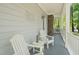 Charming porch area with white Adirondack chairs and a small table, perfect for relaxing outdoors at 3201 Keighley Forest Dr, Wake Forest, NC 27587