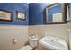 Elegant powder room featuring a pedestal sink, decorative wallpaper, and framed artwork at 3201 Keighley Forest Dr, Wake Forest, NC 27587