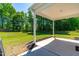 Covered porch showcasing an outdoor entertaining space with beautiful lawn and treeline views at 325 Porterfield Dr, Youngsville, NC 27596