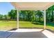 Covered porch showcasing an outdoor entertaining space with beautiful lawn and treeline views at 325 Porterfield Dr, Youngsville, NC 27596