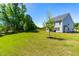 Expansive backyard with well-maintained lawn and a view of the home's back porch at 325 Porterfield Dr, Youngsville, NC 27596