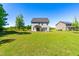 View of the home with expansive green backyard and well-manicured lawn at 325 Porterfield Dr, Youngsville, NC 27596