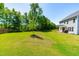 Expansive backyard with well-maintained lawn and a view of the home's back porch at 325 Porterfield Dr, Youngsville, NC 27596
