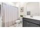 Bathroom featuring a shower with a neutral curtain, white toilet, and dark vanity with brushed silver hardware at 325 Porterfield Dr, Youngsville, NC 27596