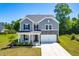 Beautiful two-story home with a well-manicured lawn and a two-car garage at 325 Porterfield Dr, Youngsville, NC 27596