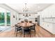 Bright, stylish eat-in kitchen featuring white cabinets, stainless steel appliances, and access to the backyard at 325 Porterfield Dr, Youngsville, NC 27596
