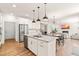 Stylish island kitchen with white cabinets, granite countertops, stainless steel appliances, and an open floor plan at 325 Porterfield Dr, Youngsville, NC 27596