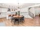 Spacious eat-in kitchen featuring white cabinets, modern stainless appliances, and a striking staircase at 325 Porterfield Dr, Youngsville, NC 27596