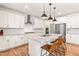 Modern kitchen featuring white cabinets, granite countertops, stainless steel appliances, and a kitchen island at 325 Porterfield Dr, Youngsville, NC 27596
