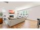 Bright living room with a fireplace, tv, hardwood floors, and large windows at 325 Porterfield Dr, Youngsville, NC 27596