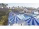 Community pool with lounge chairs, umbrellas, and open-air pavilion at 336 White Oak Garden Way # 222, Garner, NC 27529