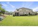 Large backyard with a screened porch, green lawn, and mature trees, ideal for outdoor enjoyment at 3406 Antler View Dr, Apex, NC 27502