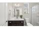 Bright bathroom with a dark vanity, a white countertop and ample lighting at 3406 Antler View Dr, Apex, NC 27502