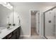 Bathroom featuring a single vanity, large mirror, shower, and walk-in closet at 3406 Antler View Dr, Apex, NC 27502