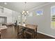 Bright dining room with high ceilings, a modern chandelier, hardwood floors, and lots of natural light at 3406 Antler View Dr, Apex, NC 27502
