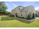 Side view of a home featuring modern siding, a brick facade, and green lawn at 3406 Antler View Dr, Apex, NC 27502
