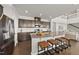 Gourmet kitchen island with seating, perfect for entertaining, with stainless steel appliances and ample counter space at 3406 Antler View Dr, Apex, NC 27502