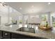 Open kitchen with a granite island with a stainless steel sink, and an open view to the dining room at 3406 Antler View Dr, Apex, NC 27502