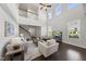 Bright and airy living room featuring high ceilings, a ceiling fan, and a view of the staircase at 3406 Antler View Dr, Apex, NC 27502