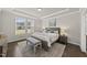 Serene main bedroom featuring tray ceilings, neutral decor, and ample natural light for a relaxing retreat at 3406 Antler View Dr, Apex, NC 27502