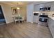 This kitchen features stainless steel appliances, sleek gray cabinets, and a cozy dining area at 3523 Ivy Commons Dr # 102, Raleigh, NC 27606