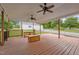 Covered back deck with ceiling fans overlooking a large back yard at 3603 Westmeadow Ln, Elon, NC 27244
