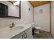 Bathroom in converted garage with sink, toilet, and framed mirror at 3603 Westmeadow Ln, Elon, NC 27244