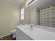Well-lit bathroom features a single sink vanity and a shower-tub combo with neutral finishes at 3603 Westmeadow Ln, Elon, NC 27244
