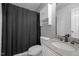 Stylish bathroom features a single sink vanity with a dark countertop and a shower-tub combo at 3603 Westmeadow Ln, Elon, NC 27244