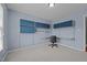 Bedroom featuring built-in shelves and a desk space with light blue walls and neutral carpet at 3603 Westmeadow Ln, Elon, NC 27244