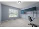 Cozy bedroom with natural light, light blue walls, desk, shelves, and neutral carpet at 3603 Westmeadow Ln, Elon, NC 27244