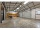 Open garage interior featuring a wood burning stove, overhead lights, and kitchenette area at 3603 Westmeadow Ln, Elon, NC 27244
