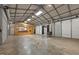 Spacious garage with high ceilings, wood stove, and partially finished with kitchenette and serving bar at 3603 Westmeadow Ln, Elon, NC 27244