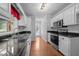 Bright kitchen with white cabinets, stainless steel appliances, and hardwood floors offers a practical layout at 3603 Westmeadow Ln, Elon, NC 27244